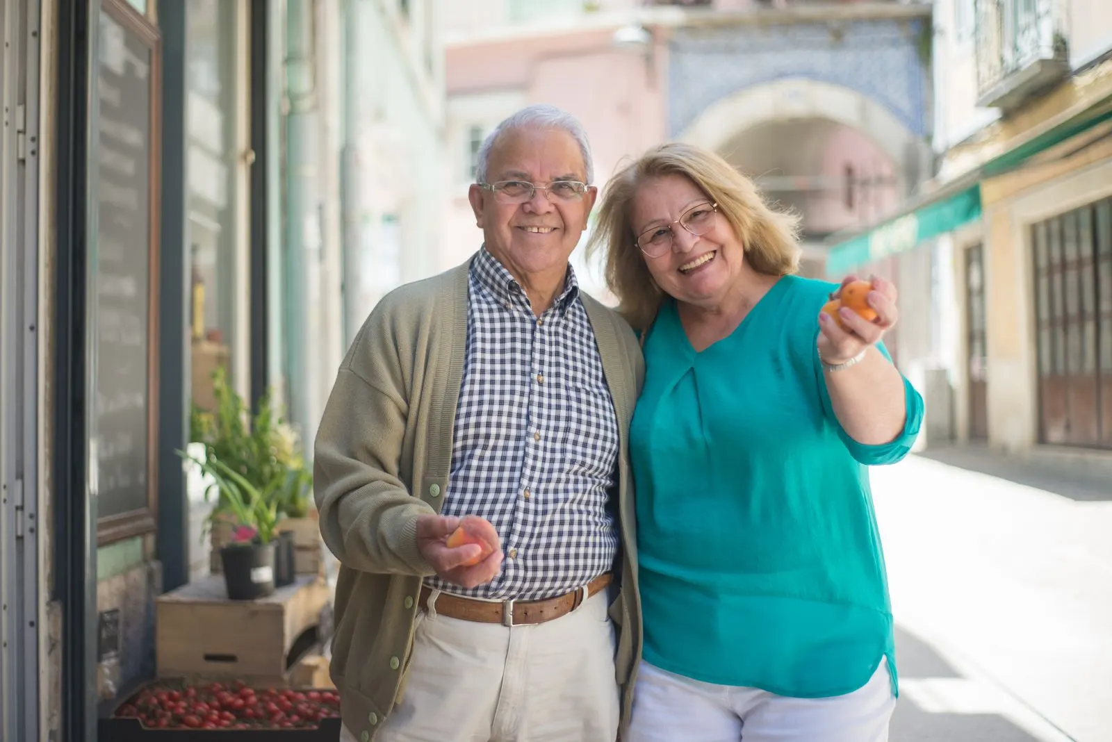 A couple choosing fruit outside a shop