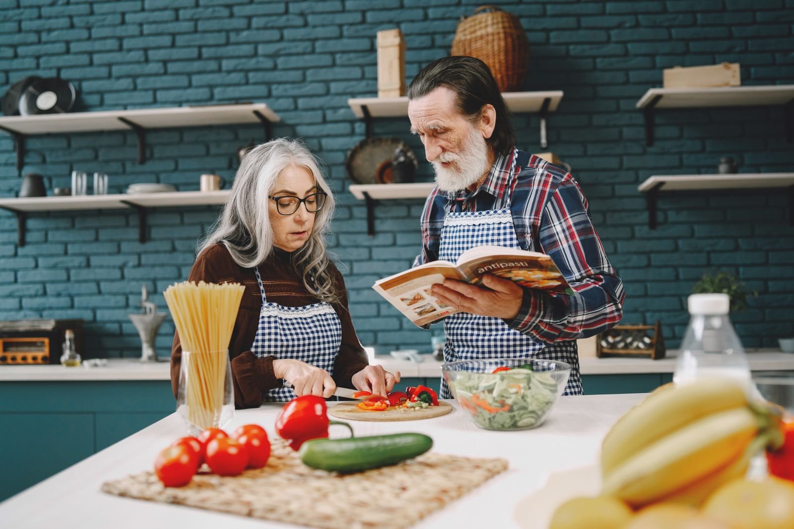 Stock photo: two people preparing vegetables together in a kitchen, illustrating meal preparation